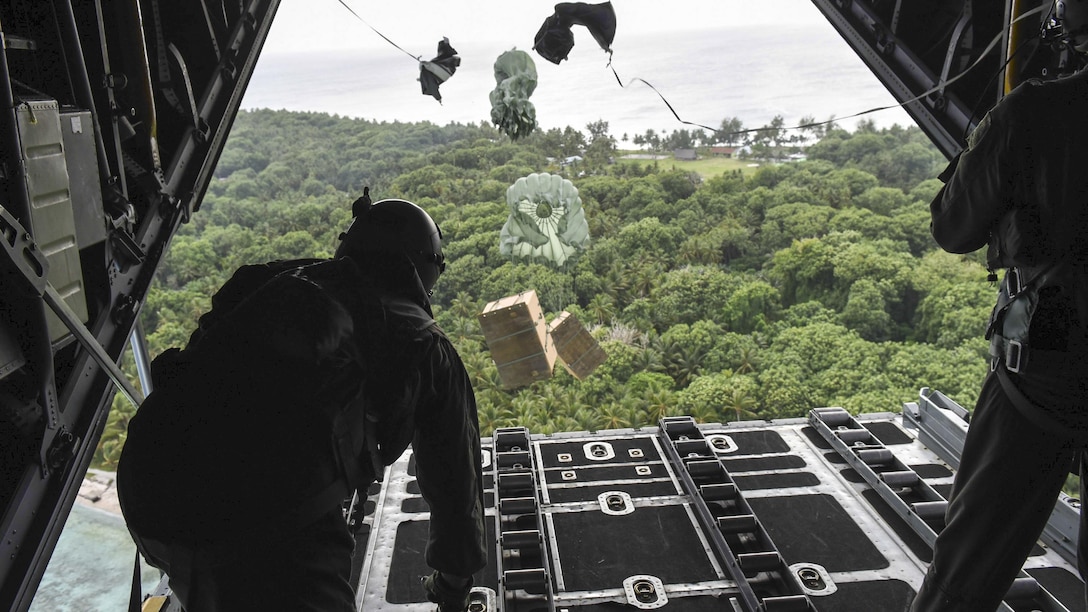 <strong>Photo of the Day: Dec. 15, 2016</strong><br/><br />Air Force Staff Sgt. Andrew Thompson and Airman 1st Class Alejandra Vargas push boxes of gifts off a C-130 Hercules during Operation Christmas Drop over an island in Micronesia, Dec. 8, 2016. This year marks 65 years of Operation Christmas Drop, a humanitarian airlift operation that provides airlift training opportunities for peace and wartime efforts. Air Force photo by Airman 1st Class Jacob Skovo<br/><br /><a href="http://www.defense.gov/Media/Photo-Gallery?igcategory=Photo%20of%20the%20Day"> Click here to see more Photos of the Day. </a> 
