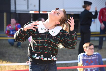 Navy Lt. Sarah Jones, department head for Naval Health Clinic Charleston's Preventive Medicine, competes in the "Face the Cookie" challenge during NHCC's "Reindeer Games" competition Dec. 9 at NHCC. During the challenge,
each competitor was required to use his or her facial muscles to move a cookie from the forehead to the mouth without using hands. 
