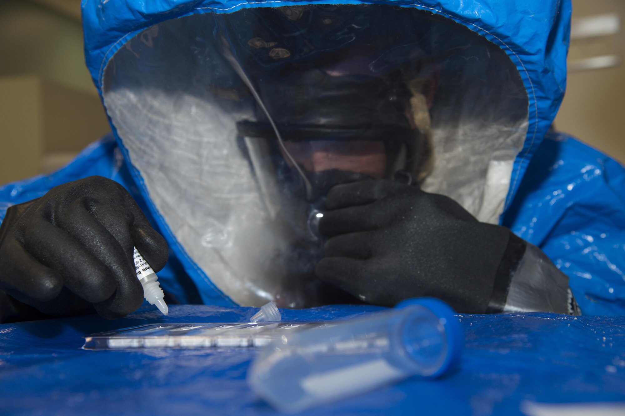 Col. Thomas Kunkel, 23d Wing commander, attempts to place a solution of a simulated chemical into a tester during an immersion tour Dec. 12, 2016, at Moody Air Force Base, Ga. The immersion tour allowed wing leadership to experience a day in the life of Airmen from the bioenvironmental flight. The bioenvironmental flight uses these tools to test for hundreds of chemical compounds during crisis situations. (U.S. Air Force photo by Staff Sgt. Eric Summers Jr.)