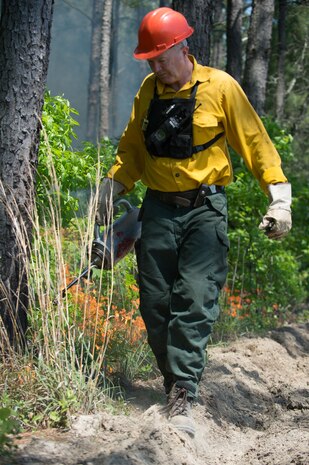 JB Charleston Natural Resources Manager Terrence Larimer sets prescribed fire with a drip torch on JB Charleston – WS, February 2016. The primary goal of prescribed fire is to prevent and minimize wildfire by reducing fuel loads in the 12,000 acres of managed forest land here.