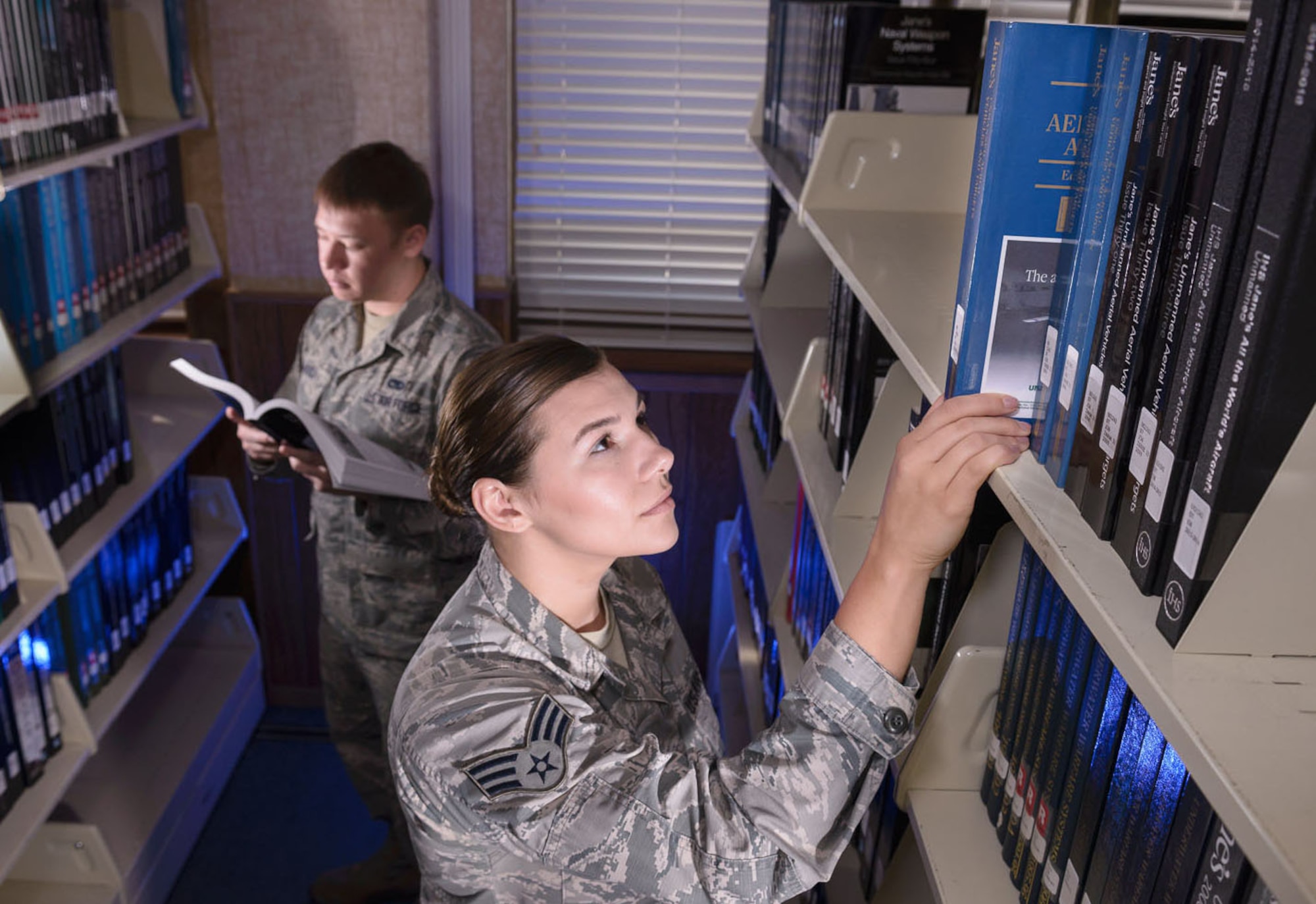 Producing mission data begins with research. Senior Airman Chad and Senior Airman Elizabeth, research analysts, study a variety of aircraft in the 57th IS library. The library, located within 25th Air Force Headquarters, is one of only a few official Air Force libraries.