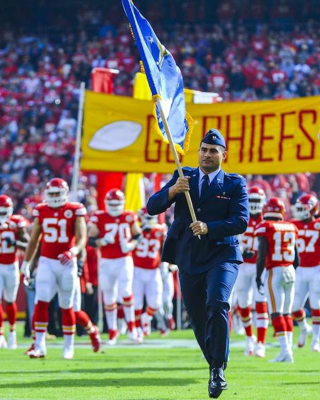 Capt. Fabian Tafuna, 22nd Air Refueling Wing chaplain, carries the Air Force flag before at a Kansas City Chiefs football game in honor of Veteran's Day, Nov. 6, 2016, Arrowhead Stadium, Mo. Before joining the Air Force, Tafuna played football as a fullback at Weber State University, Utah. (U.S. Air Force photo/Senior Airman Christopher Thornbury)