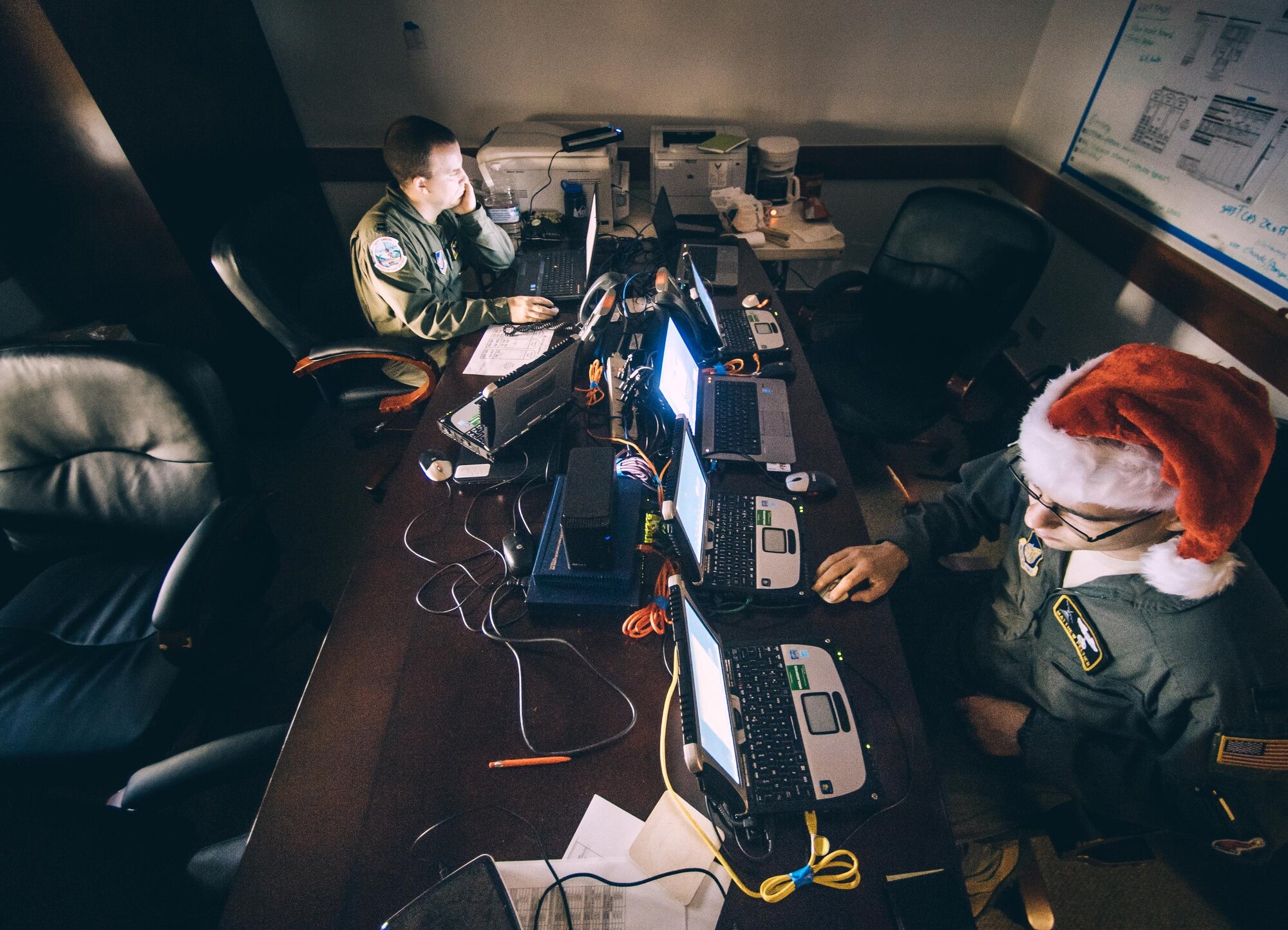 Capt. David Lynn, left, and Capt. Matthew Peltier, 36th Airlift Squadron C-130 Hercules navigators, plan a mission during Operation Christmas Drop 2016 at Andersen Air Force Base, Guam, Dec. 11, 2016. Operation Christmas Drop highlights the U.S. and allied airpower capabilities to orient and respond to activities in peacetime and crisis. (U.S. Air Force photo by Senior Airman Delano Scott/Released)