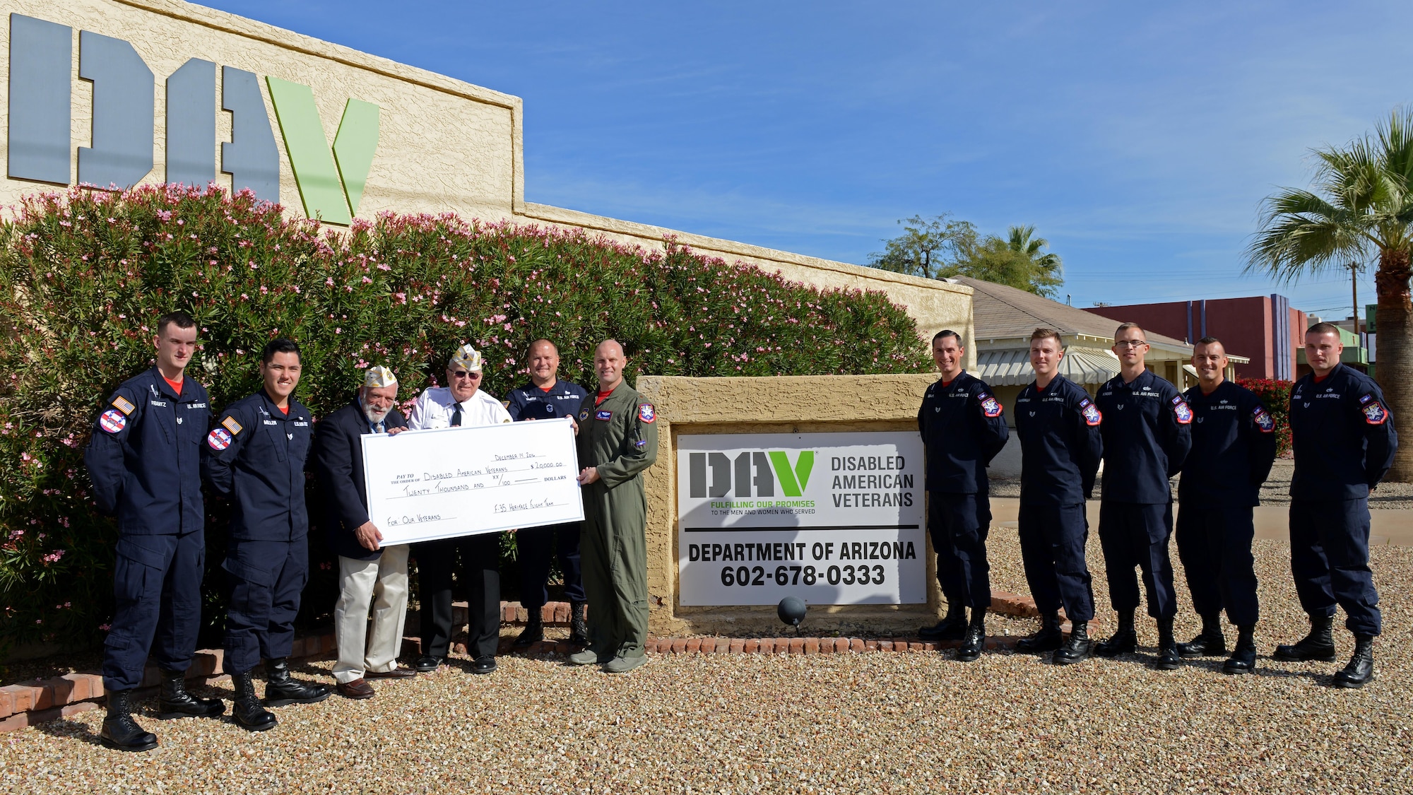 The F-35 Heritage Flight Team donates a 20 thousand dollar charity check to the Disabled Veterans Office Dec. 14, 2016, Phoenix, Ariz. The donations given to the DAV will help the organization fund programs, like healthcare services, psychological counseling, physical rehabilitation, job training and residential relocation. (U.S. Air Force photo by Airman 1st Class Pedro Mota)