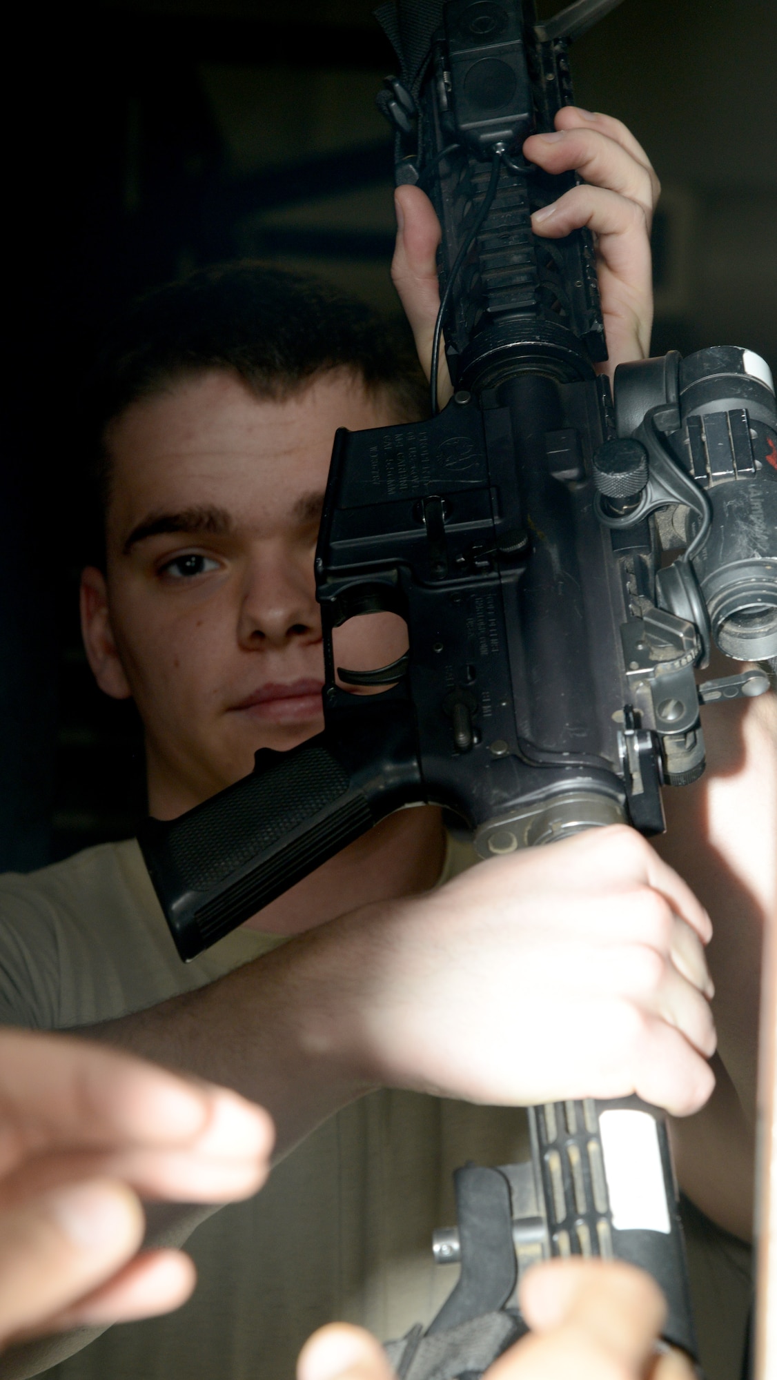 Senior Airman Preston Pearce, 412th Security Forces Squadron armorer, checks out a weapon to another SFS member. The SFS recently briefed privately owned weapons registration, storage and transportation requirements at a town hall meeting here. (U.S. Air Force photo by Christopher Ball)