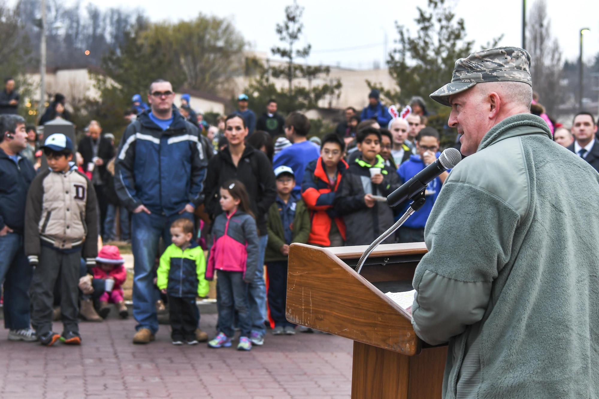 Col. Andrew Hansen, 51st Fighter Wing commander, addresses service members and their families at the opening of the Christmas tree lighting ceremony at Osan Air Base, Republic of Korea, Dec. 8, 2016. Hansen encouraged everyone to support and care for themselves and to not miss out on any festivities going on around the base. (U.S. Air Force photo by Tech. Sgt. Rasheen Douglas)