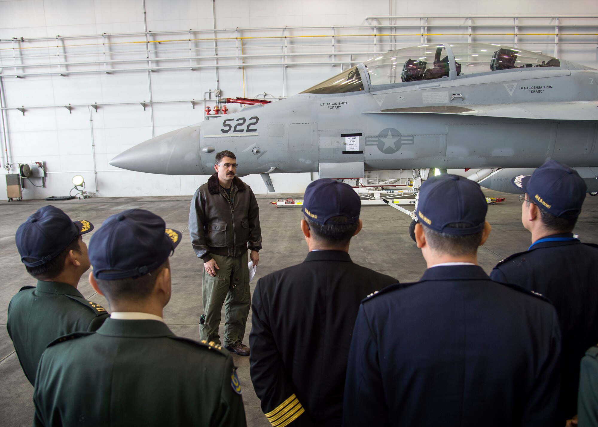 U.S. Navy Lt. Shaun Randall, the Naval Air Facility Misawa VAQ-135 training officer, briefs Japanese and Republic of Korea colonels and lieutenant colonels on the mission and capabilities of the EA-18G Growler at Misawa Air Base, Japan, Dec. 13, 2016. In addition to seeing the EA-18G, Japanese and Republic of Korea leaders listened to a mission brief on the F-16 Fighting Falcon and the Air Force’s presence in Misawa. (U.S. Air Force photo by Senior Airman Deana Heitzman)