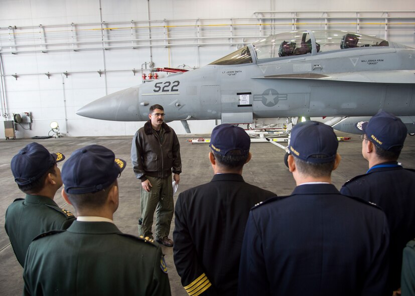 U.S. Navy Lt. Shaun Randall, the Naval Air Facility Misawa VAQ-135 training officer, briefs Japanese and Republic of Korea colonels and lieutenant colonels on the mission and capabilities of the EA-18G Growler at Misawa Air Base, Japan, Dec. 13, 2016. In addition to seeing the EA-18G, Japanese and Republic of Korea leaders listened to a mission brief on the F-16 Fighting Falcon and the Air Force’s presence in Misawa. (U.S. Air Force photo by Senior Airman Deana Heitzman)