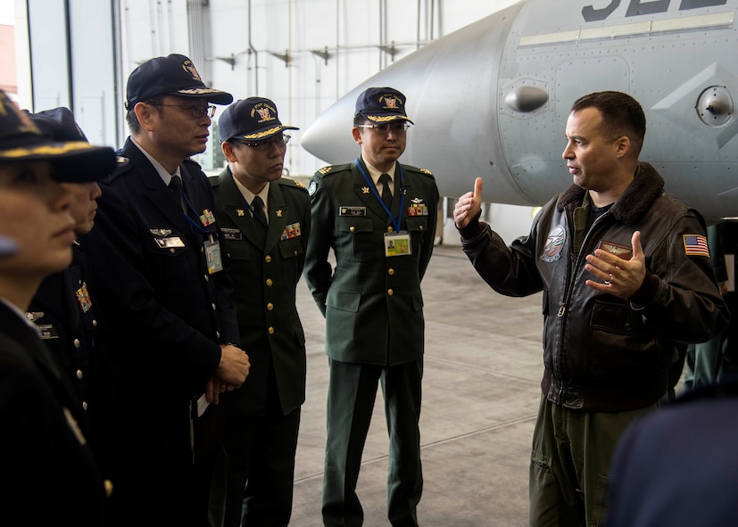 U.S. Navy Cmdr. Kevin Volpe, VAQ-135 electronic warfare officer, briefs Japanese and Republic of Korea colonels and lieutenant colonels on the mission and capabilities of the EA-18G Growler at Misawa Air Base, Japan, Dec. 13, 2016. The Japanese and Republic of Korea leaders are a part of a Senior Officers Leadership Course touring Japanese military installations across the Aomori Prefecture and Hokkaido, Japan. (U.S. Air Force photo by Senior Airman Deana Heitzman)