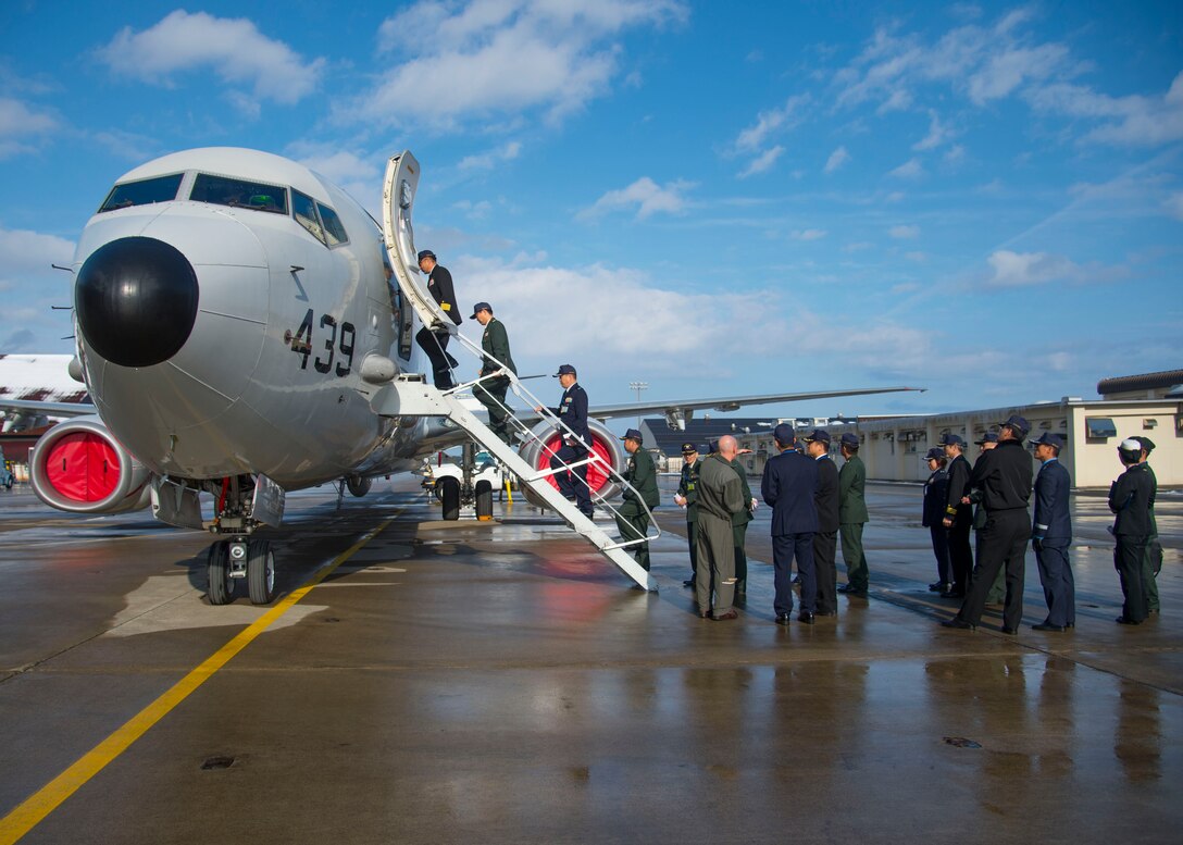 Japanese and Republic of Korea colonels and lieutenant colonels tour inside a Navy P-8 Poseidon during a leg of the Senior Officers Leadership Course at Misawa Air Base, Japan, Dec. 13, 2016. These leaders are touring military installations across Northern Japan while learning the missions and capabilities of each installation. (U.S. Air Force photo by Senior Airman Deana Heitzman)