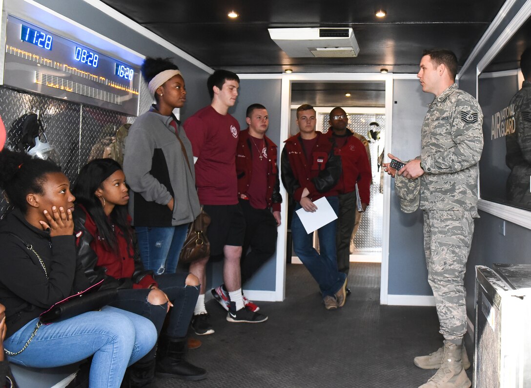 U.S. Air Force Technical Sgt. Jarred Mattox a Georgia Air National Guard recruiter with the 116th Air Control Wing showcases the new Georgia Air National Guard interactive trailer while speaking to JROTC students about the various career fields and benefits of serving in the Air National Guard, Robins Air Force Base, Ga., Dec. 2, 2016.  Recruiters from the 116th ACW spoke to JROTC students from Warner Robins and Callaway High Schools about career opportunities and about domestic operations and federal missions. (U.S. Air National Guard photo by Master Sgt. Regina Young)