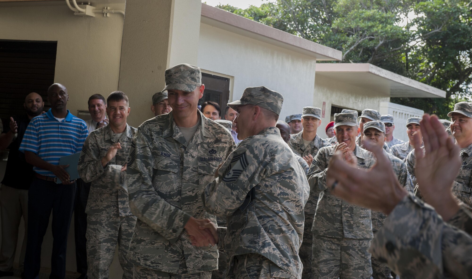 U.S. Air Force Senior Master Sgt. Michael Knox, 18th Civil Engineer Squadron operations flight chief, is congratulated by Chief Master Sgt. Dustin Green, 18th Civil Engineer Group superintendent, Dec. 8, 2016, at Kadena Air Base, Japan. Eight of Kadena’s senior master sergeants were selected for promotion to the rank of chief master sergeant. (U.S. Air Force photo by Senior Airman Lynette M. Rolen/Released)