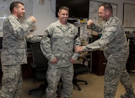 U.S. Air Force Brig. Gen. Barry Cornish, left, 18th Wing commander and Lt. Col. Richard Worcester, right, 718th Aircraft Maintenance Squadron commander, tack on the rank of chief master sergeant to Senior Master Sgt. Harold Frithsen, 33rd Helicopter Maintenance Unit maintenance superintendent Dec. 8, 2016, at Kadena Air Base, Japan. The rank of chief master sergeant is the highest rank possible for enlisted members in the U.S. Air Force. (U.S. Air Force photo by Senior Airman Lynette M. Rolen/Released)