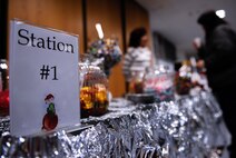 Families bundle up inside for some hot chocolate, candy, and s’mores at the first Elf Bootcamp station at Ramstein Air Base, Germany, Dec. 12, 2016. Upon entering the second annual Elf Bootcamp, children filled out elf applications and received an elf ID before the festivities began. During the holiday celebration, stations were set up to hone elf skills such as crafts, elf games, and a cookie station. (U.S. Air Force photo by Airman 1st Class Savannah L. Waters)