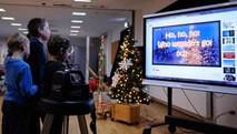 Owen, Jacob, and Elliot Porter, children of Staff Sgt. Adam Porter, United States Air Forces in Europe Band regional bandsman, sing karaoke during Elf Bootcamp at Ramstein Air Base, Germany, Dec. 12, 2016. Children reported for elf duty at the Ramstein Community Center to have fun and participate in elf-themed holiday activities. (U.S. Air Force photo by Airman 1st Class Savannah L. Waters)