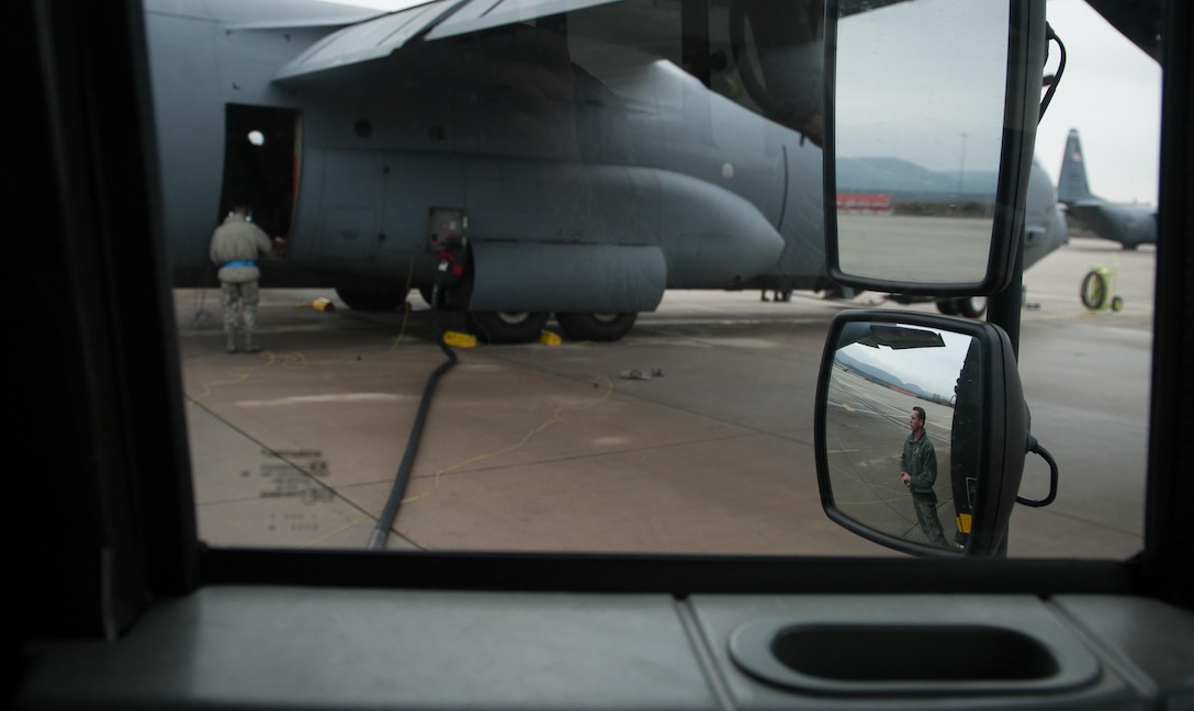 Airman 1st Class Austin Bashaw, 86th Logistics Readiness Squadron fuels specialist, observes as fuel is pumped into a C-130J Super Hercules at Ramstein Air Base, Germany, Dec. 12, 2016. Fuels specialists work with maintenance Airmen, as well as pilots throughout the process of transporting fuel to aircraft across the flightline. (U.S. Air Force photo by Airman 1st Class Lane T. Plummer)