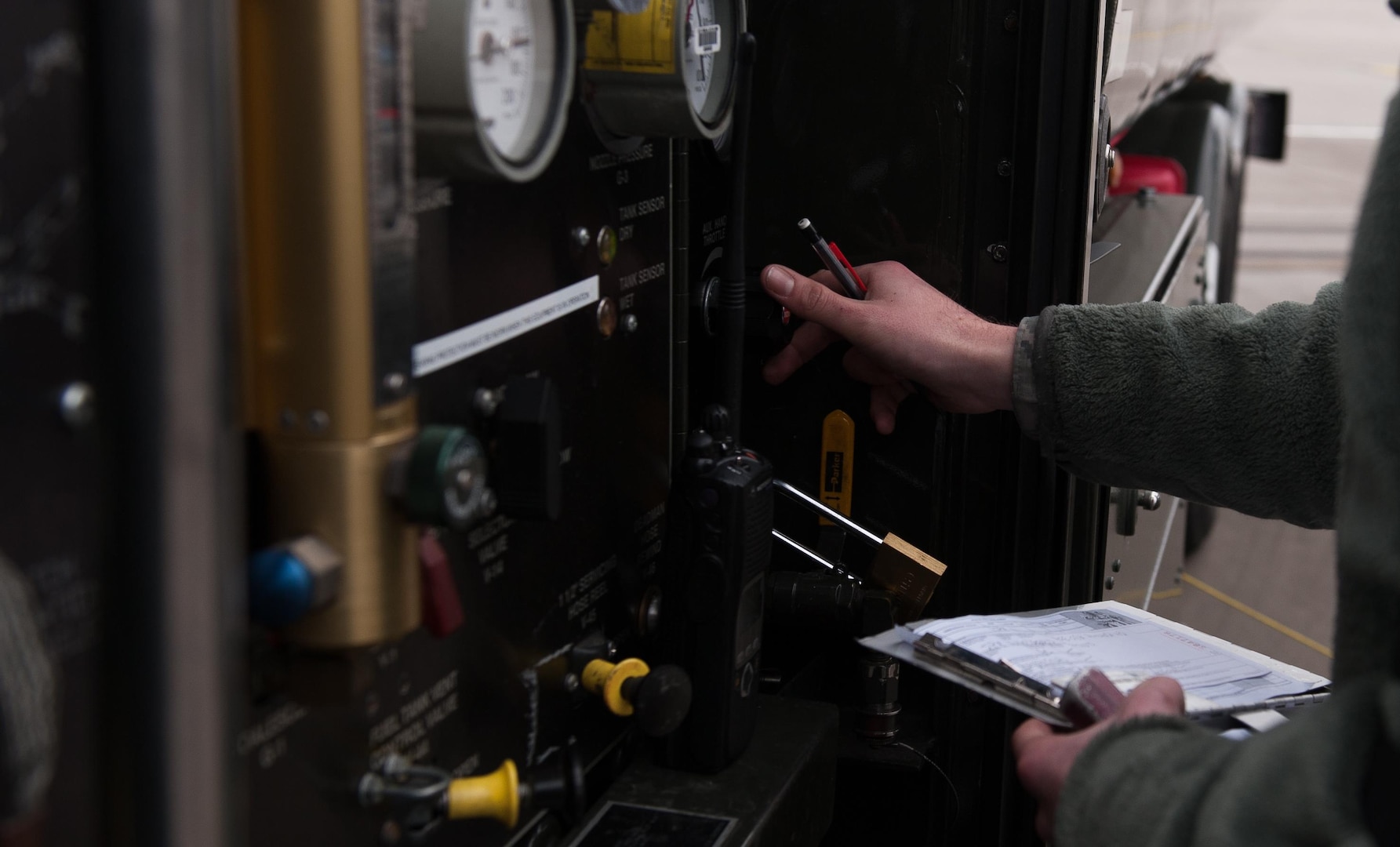 Airman 1st Class Austin Bashaw, 86th Logistics Readiness Squadron fuels specialist, adjusts the output from a fuel truck during a refueling operation at Ramstein Air Base, Germany, Dec. 12, 2016. It is the job of fuels specialists to manage every aspect of refueling for every aircraft on the flight line. (U.S. Air Force photo by Airman 1st Class Lane T. Plummer)