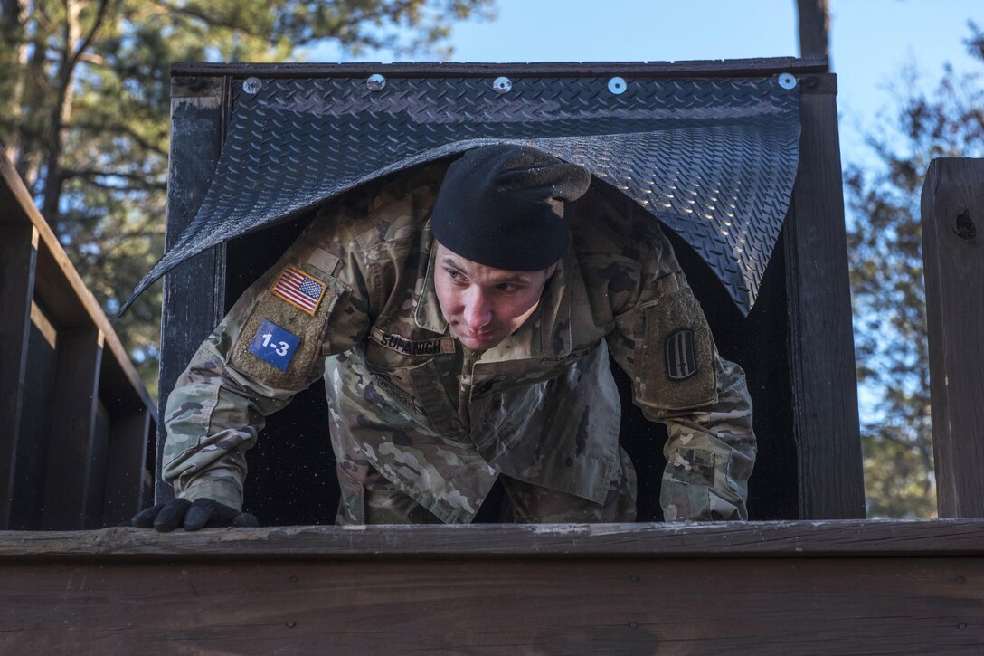 A soldier completes the night crawler obstacle while participating in the Rubicon Command Team Challenge at Fort Jackson, S.C., Dec. 9, 2016. Army photo by Sgt. 1st Class Brian Hamilton 