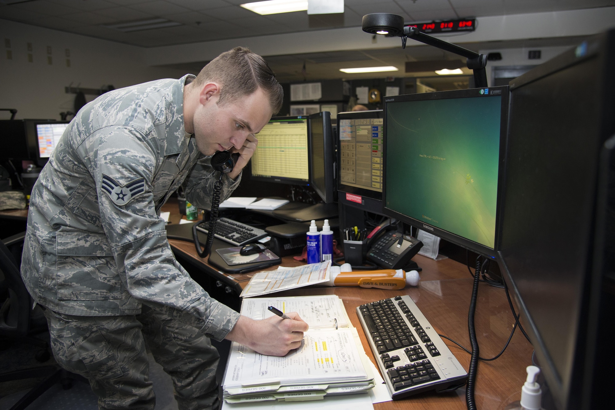 Senior Airman Thomas Ozman, 436th Airlift Wing Command Post controller, runs a Quick Reaction Checklist for a ground emergency Dec. 14, 2016, in the command post on Dover Air Force Base, Del. Command post controllers are responsible for tracking all missions arriving at and departing from the installation, coordinating with operations centers on the installation and disseminating information to the base populous. (U.S. Air Force photo by Senior Airman Aaron J. Jenne)