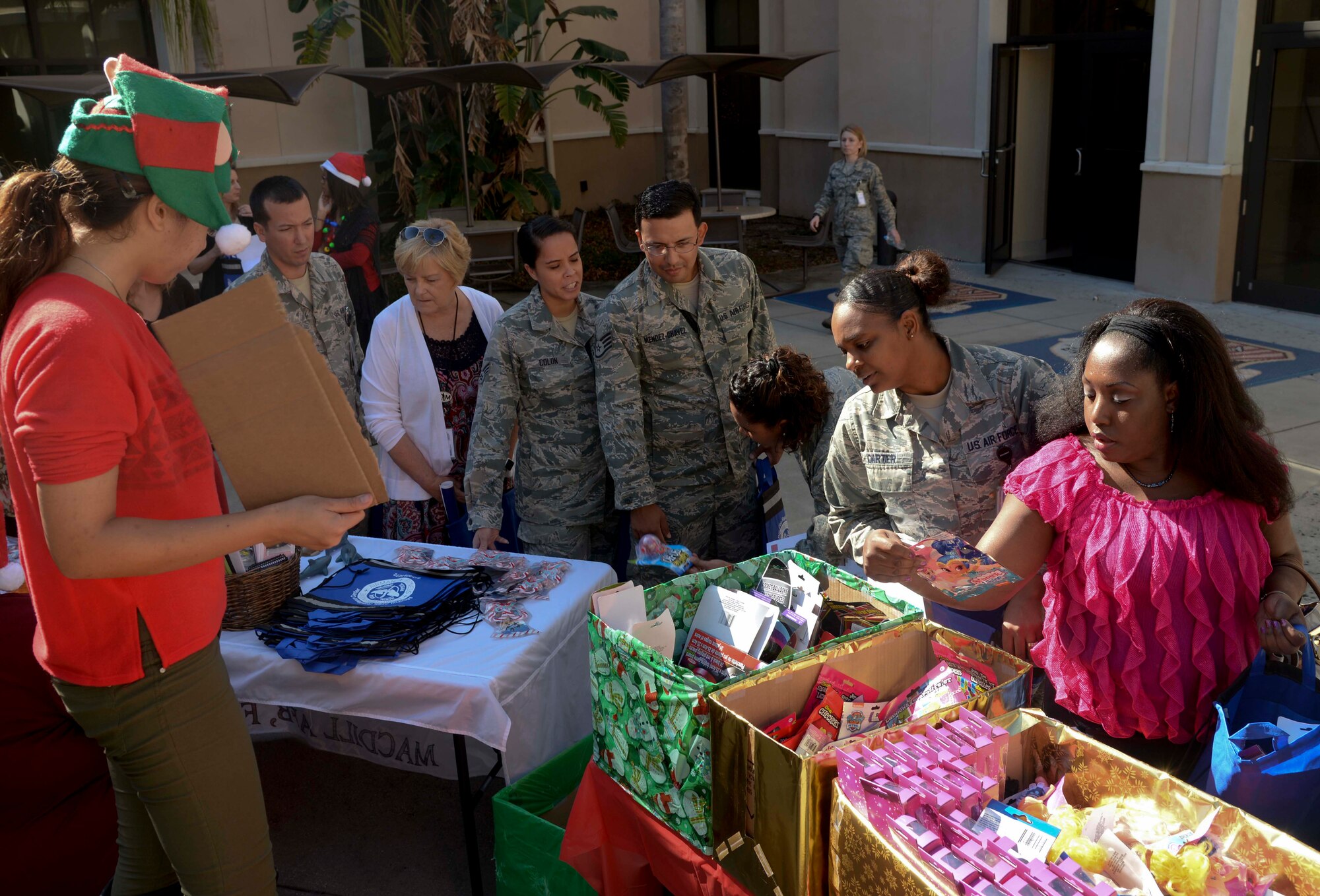 Personnel assigned to the 6th Medical Group (MDG) select free toys during the 6th MDG appreciation event at MacDill Air Force Base, Fla., Dec. 14, 2016. Medical personnel also received free refreshments and “thank you” cards, as well as a musical performance from the Air Force Band of the West Clarinet Quartet. (U.S. Air Force photo by Senior Airman Vernon L. Fowler Jr.)