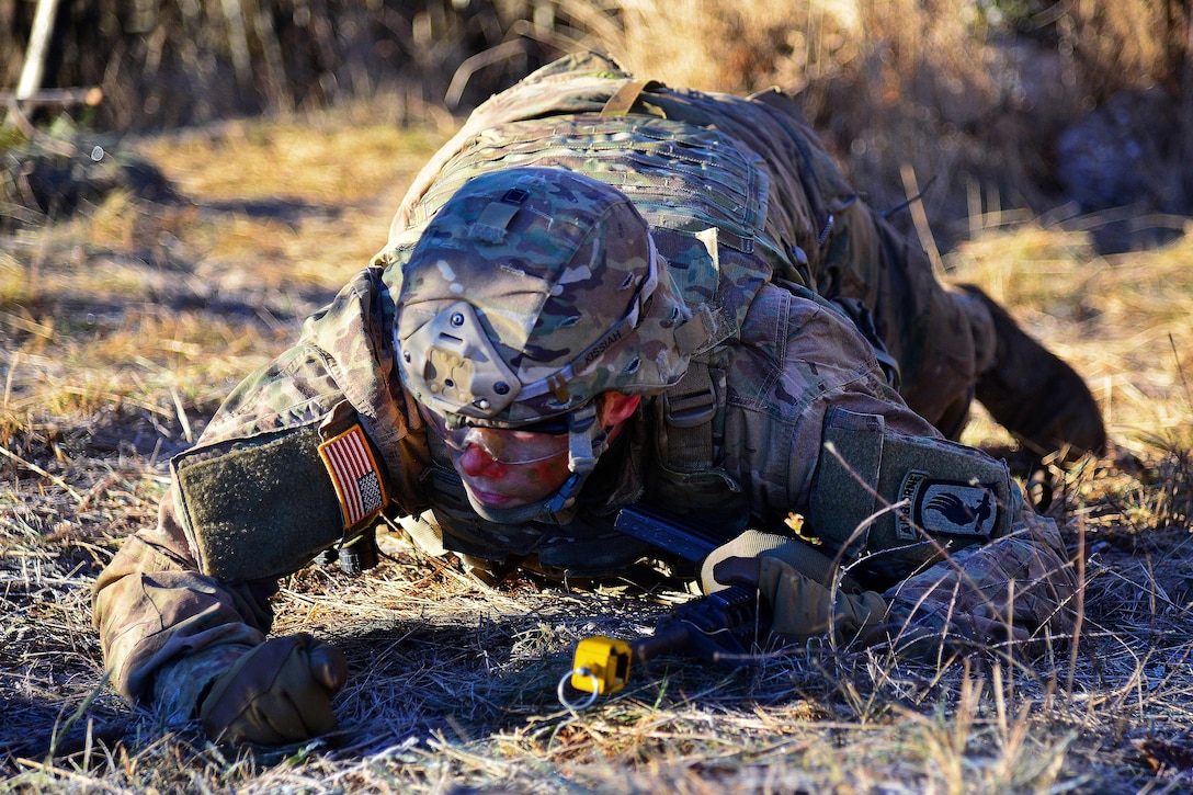 A soldier crawls to a forward firing position during a live-fire exercise as part of Exercise Mountain Shock at Pocek Range in Slovenia, Dec. 9, 2016. Army photo by Davide Dalla Massara