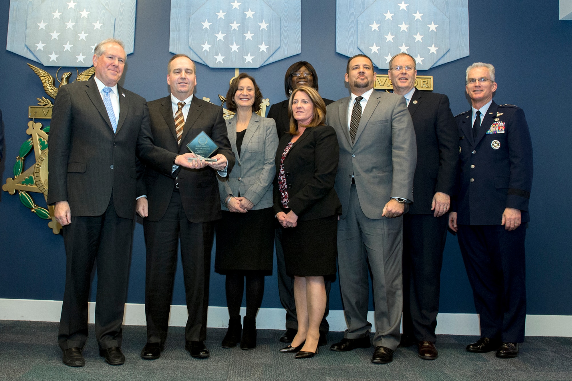 Frank Kendall, Under Secretary of Defense for Acquisition, left, presents members of the Resource Management Division with the Defense Acquisition Resource Management Award during a ceremony at the Pentagon on Dec. 8, 2016. Standing with them are Vice Chairman of the Joint Chiefs of Staff Gen. Paul J. Selva right, and Deputy Secretary of Defense Bob Work. (DoD photo) 