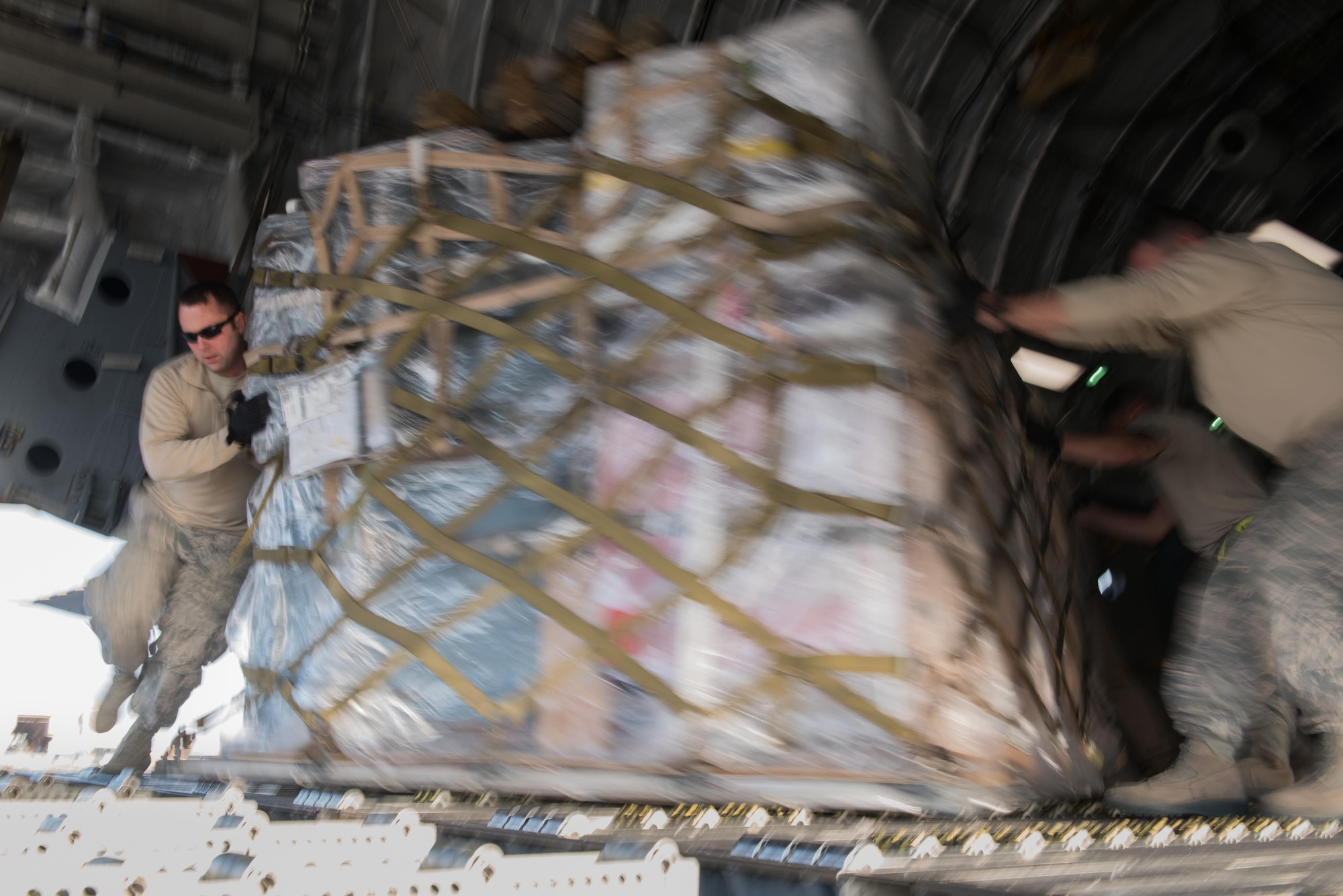 Staff Sgt. Harry Carnell, 407th Expeditionary Logistics Readiness Squadron air terminal operations NCO in charge, unloads cargo from a C-17 Globemaster III from Joint Base Lewis-McChord, Wash., delivering supplies to the 407th Air Expeditionary Group Dec. 6, 2016, in preparation for the arrival of an F-16 squadron. An advanced team prepared the installation for the arrival of the fighter jets, enabling the squadron to begin combat missions within 24 hours of arrival. (U.S. Air Force photo/Master Sgt. Benjamin Wilson)(Released)