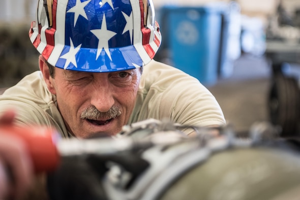 Vermont Air National Guard Master Sgt. Peter Callahan, 134th Expeditionary Fighter Squadron weapons maintenance technician, ensures the forward laser strap of a of a 500-pound joint direct attack munition is straight during the assembly process at the 407th Air Expeditionary Group, Southwest Asia, Dec. 2, 2016. The bombs will be used to fight ISIL in Iraq, which is a threat to the international community. (U.S. Air Force photo/Master Sgt. Benjamin Wilson)(Released)