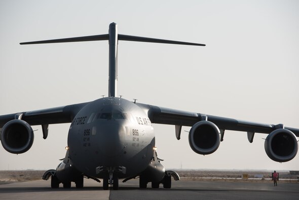 A C-17 Globemaster III from Joint Base Lewis-McChord, Wash., delivers supplies to the 407th Air Expeditionary Group Dec. 6, 2016, in preparation for the arrival of an expeditionary fighter squadron. An advanced team prepared the installation for the arrival of the fighter jets, enabling the squadron to begin combat missions within 24 hours of arrival. (U.S. Air Force photo/Master Sgt. Benjamin Wilson)