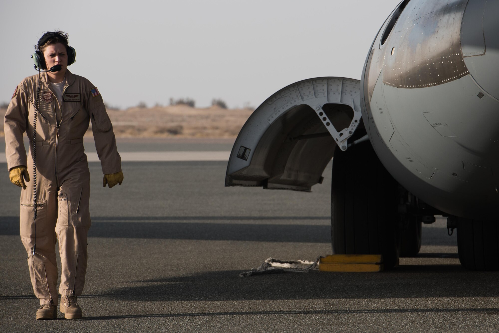 Airman 1st Class Danielle Armstrong, 8th Airlift Squadron loadmaster, performs post-flight checks on a A C-17 Globemaster III from Joint Base Lewis-McChord, Wash., delivering supplies to the 407th Air Expeditionary Group Dec. 6, 2016, in preparation for the arrival of an F-16 squadron. An advanced team prepared the installation for the arrival of the fighter jets, enabling the squadron to begin combat missions within 24 hours of arrival. (U.S. Air Force photo/Master Sgt. Benjamin Wilson)(Released)