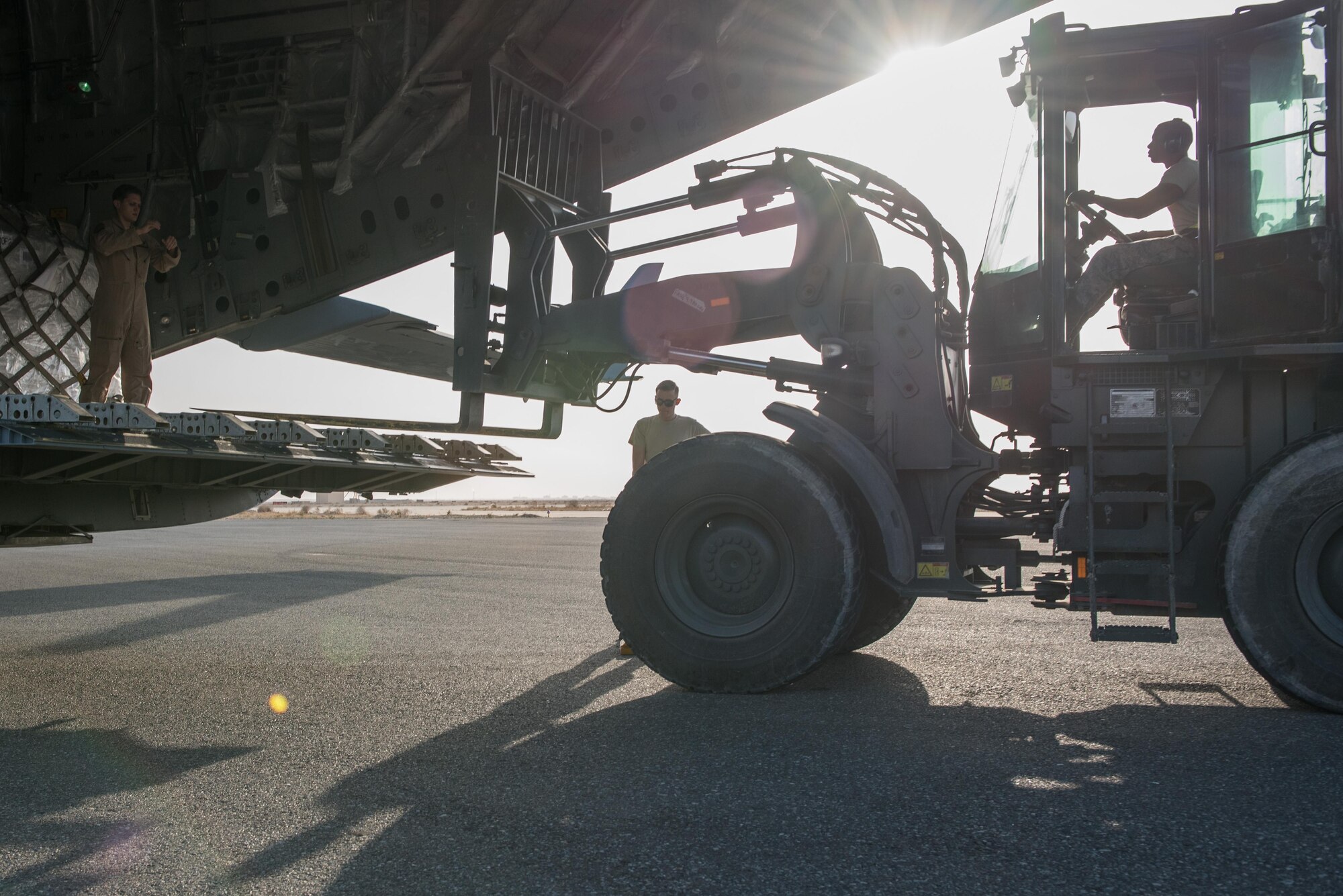 Airmen from the 407th Expeditionary Logistics Readiness Squadron and the 8th Airlift Squadron unload cargo from a C-17 Globemaster III from Joint Base Lewis-McChord, Wash., delivering supplies to the 407th Air Expeditionary Group Dec. 6, 2016, in preparation for the arrival of an F-16 squadron. An advanced team prepared the installation for the arrival of the fighter jets, enabling the squadron to begin combat missions within 24 hours of arrival. (U.S. Air Force photo/Master Sgt. Benjamin Wilson)(Released)