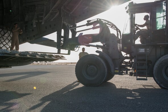 Airmen from the 407th Expeditionary Logistics Readiness Squadron and the 8th Airlift Squadron unload cargo from a C-17 Globemaster III from Joint Base Lewis-McChord, Wash., delivering supplies to the 407th Air Expeditionary Group Dec. 6, 2016, in preparation for the arrival of an expeditionary fighter squadron. An advanced team prepared the installation for the arrival of the fighter jets, enabling the squadron to begin combat missions within 24 hours of arrival. (U.S. Air Force photo/Master Sgt. Benjamin Wilson)