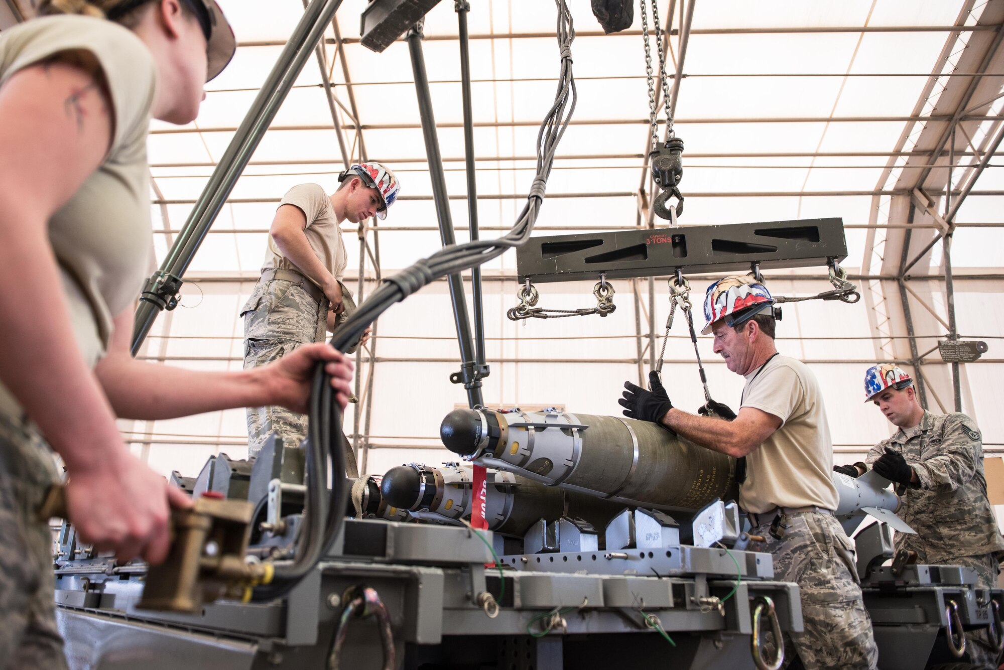 Airmen from the Vermont Air National Guard transport a 500-pound joint direct attack munition from the assembly line at the 407th Air Expeditionary Group, Southwest Asia, Dec. 2, 2016. The Airmen are part of an advanced team preparing for the arrival of Vermont ANG F-16 Fighting Falcons, which will be used against ISIL in Operation Inherent Resolve. (U.S. Air Force photo/Master Sgt. Benjamin Wilson)(Released)