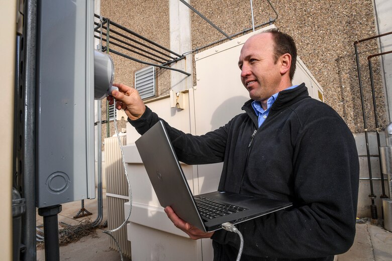 Aaron Erickson, 309th Maintenance Support Group energy manager, pulls high-resolution data from a meter at building 843, Hill Air Force Base, Dec. 13. The data will be analyzed for energy consumption trends and spikes. Erickson was recently named as the 2016 Energy Champion of the Year for the base. (U.S. Air Force photo by Paul Holcomb)
