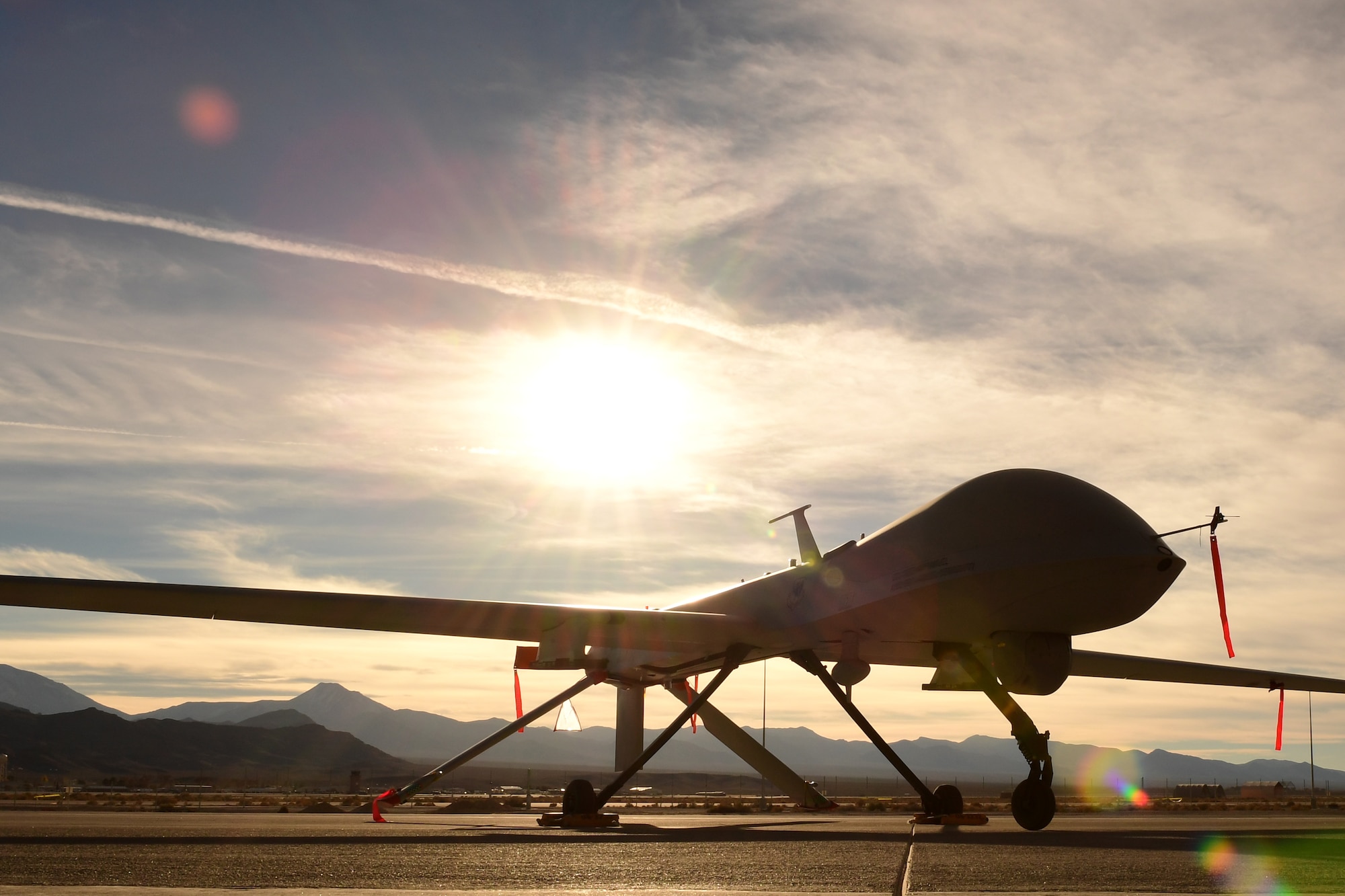 An MQ-1 Predator sits on the flight line Dec. 8, 2016, at Creech Air Force Base, Nev. The predator started as an RQ-1 in the late 1990s providing reconnaissance capabilities only until the early 2000s when it was equipped with two AGM-114 Hellfire missiles. (U.S. Air Force photo by Senior Airman Christian Clausen)