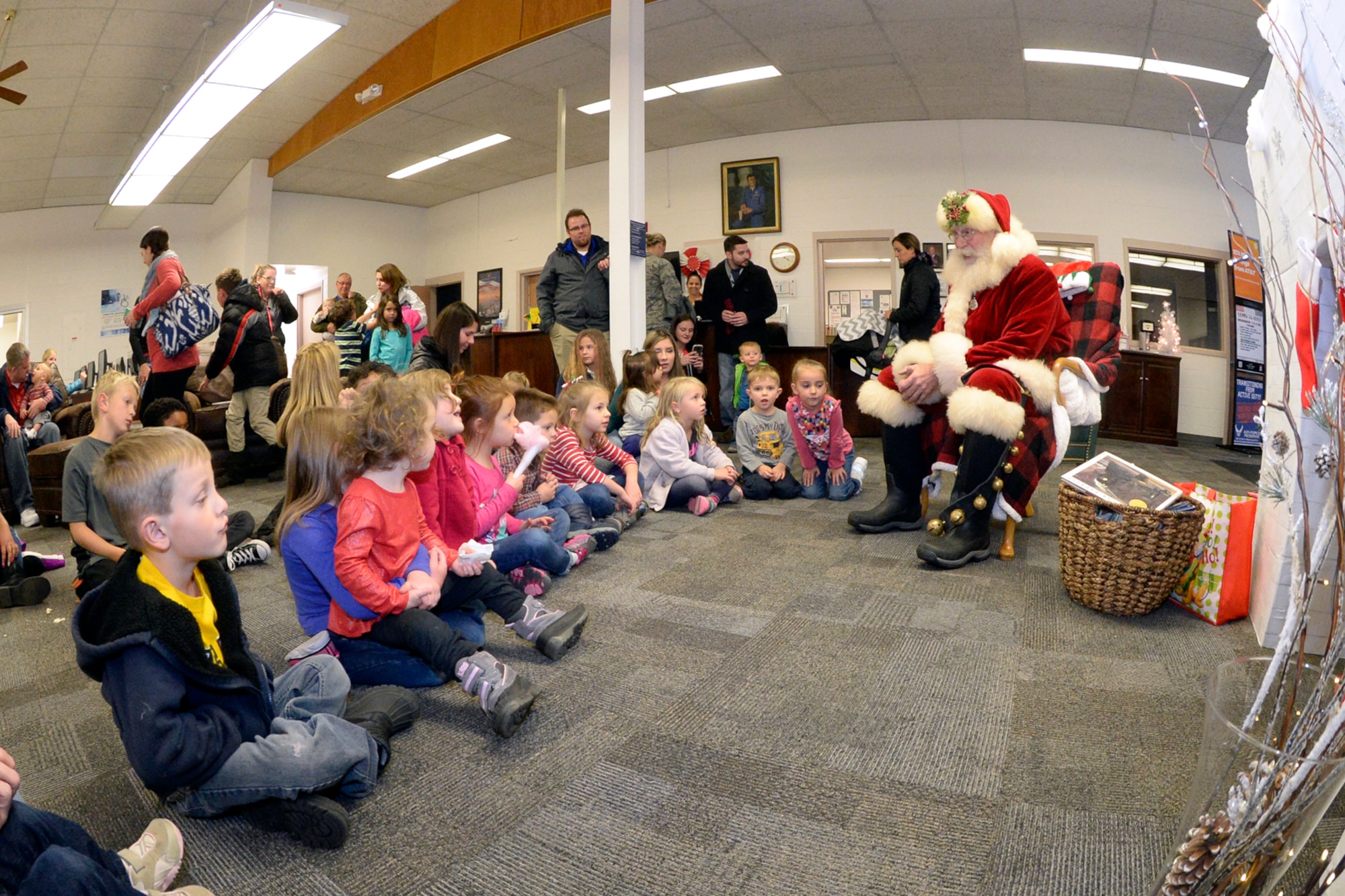 Santa visits with children during the Winter Wonderland celebration at the Hill Air Force Base Library, Dec. 8, 2016.  The event provided base families a chance to chat with Santa, enjoy refreshments, and participate in craft activities. (U.S. Air Force photo by Todd Cromar)