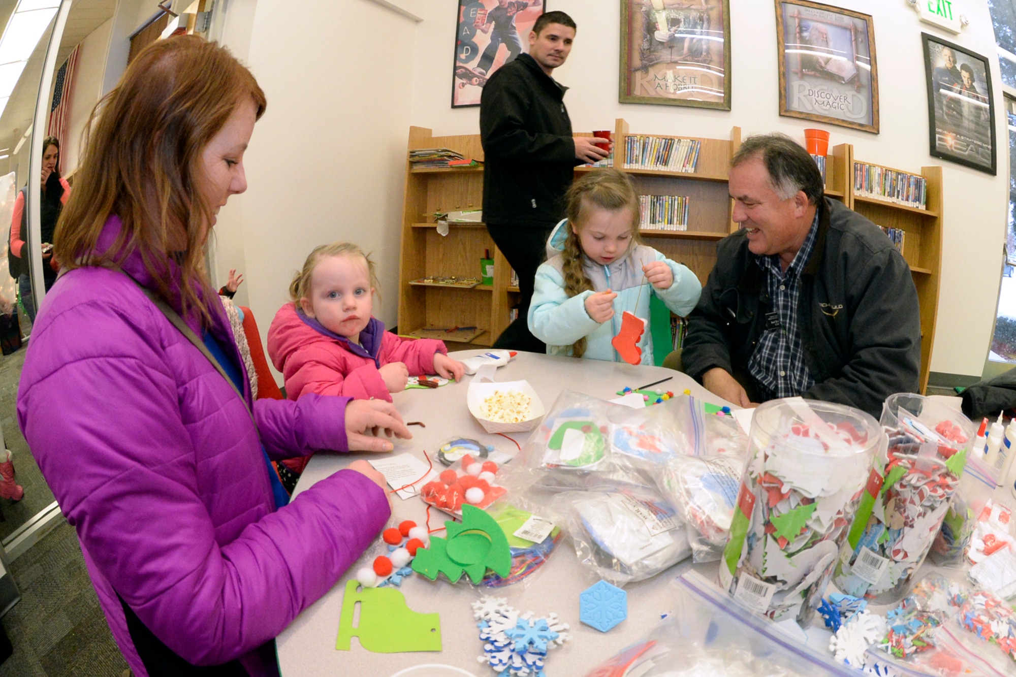 From the left, Jennifer Shaw with daughters McKenna and Hailey, and Joel Randley make ornaments at the Hill Air Force Base Library, Dec. 8, 2016. (U.S. Air Force photo by Todd Cromar)