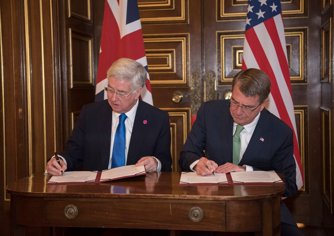 Defense Secretary Ash Carter and U.K. Defense Secretary Michael Fallon sign a carrier strategic guidance document in London before a meeting of defense ministers from nations participating in the coalition to counter the Islamic State of Iraq and the Levant, Dec. 15, 2016. DoD photo by Air Force Tech. Sgt. Brigitte N. Brantley