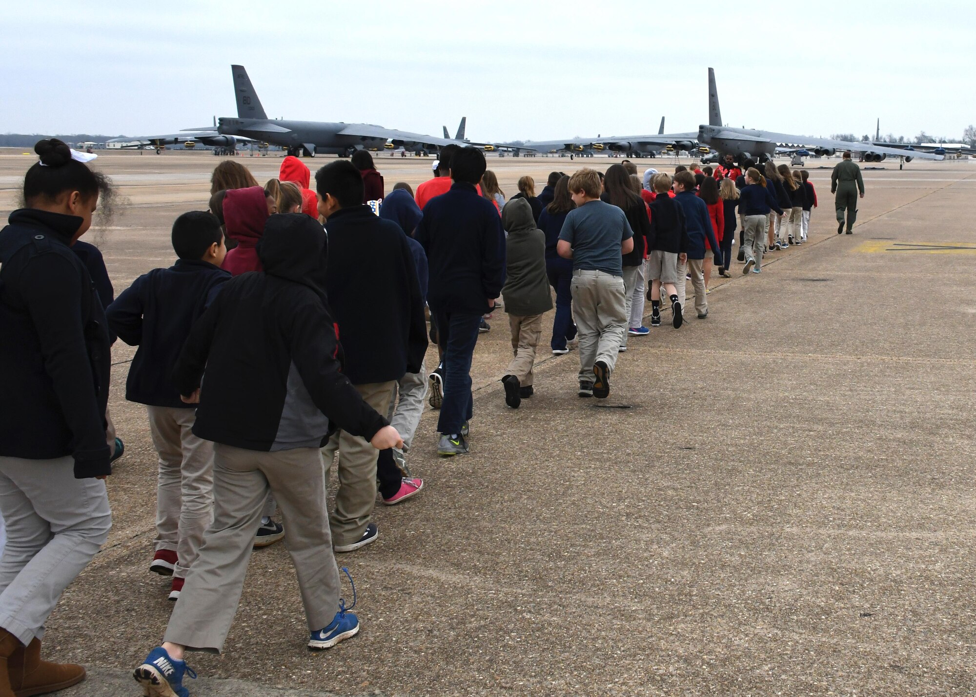 More than 80 fifth graders with STARBASE Louisiana head toward a B-52 Stratofortress during a tour of the jet Dec. 14, 2016 at Barksdale Air Force Base, La.  The tour taught student everything from security issues like entry control points, to how the pilots and navigators of the jet do their jobs. STARBASE Louisiana, is a premier Department of Defense STEM (science, technology, engineering, and mathematics) program sponsored by the 307th Bomb Wing of the Air Force Reserve Command. (U.S. Air Force photo by Tech. Sgt. Ted Daigle/Released)