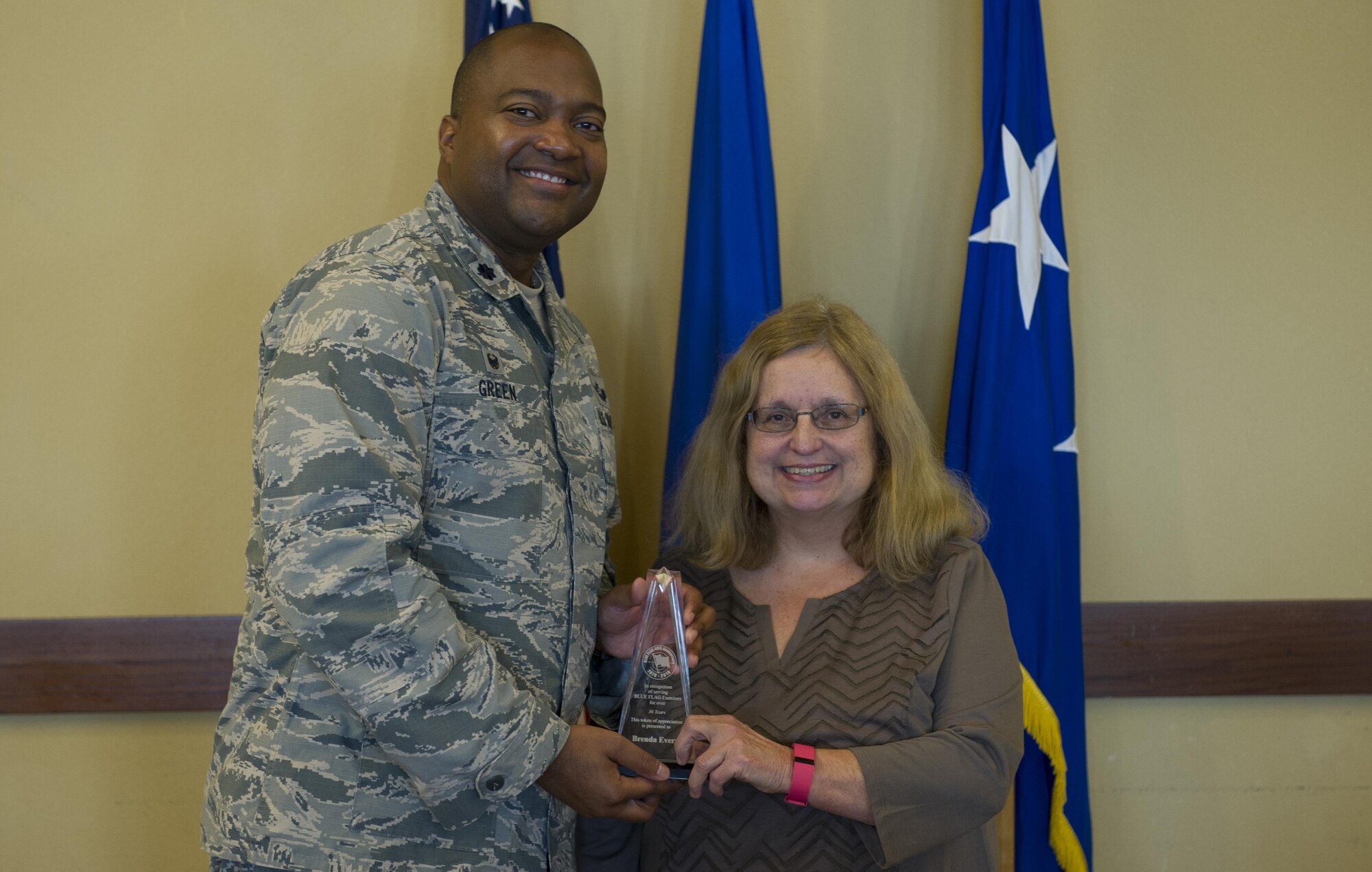 Lt. Col. Merrick Green, left, commander of the 505th Combat Training Squadron, presents Brenda Every, a systems analyst with the 505th CTS, with an award during the Blue Flag exercise 40th anniversary luncheon at Hurlburt Field, Fla., Dec. 13, 2016. Every has served and contributed to Blue Flag exercises for more than 36 years. (U.S. Air Force photo by Airman 1st Class Joseph Pick)