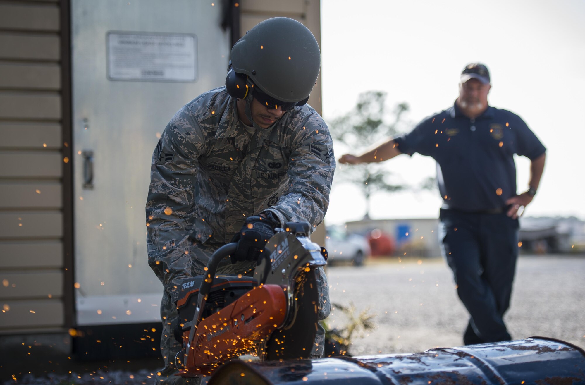 Airman 1st Class Justice Padilla, a defender with the 1st Special Operations Security Forces Squadron, uses a power cutter to cut through a metal drum at Hurlburt Field, Fla., Dec. 13, 2016. Air Commandos participated in power tool training to enhance real-world emergency response capabilities to ensure global readiness. (U.S. Air Force photos by Airman 1st Class Joseph Pick)