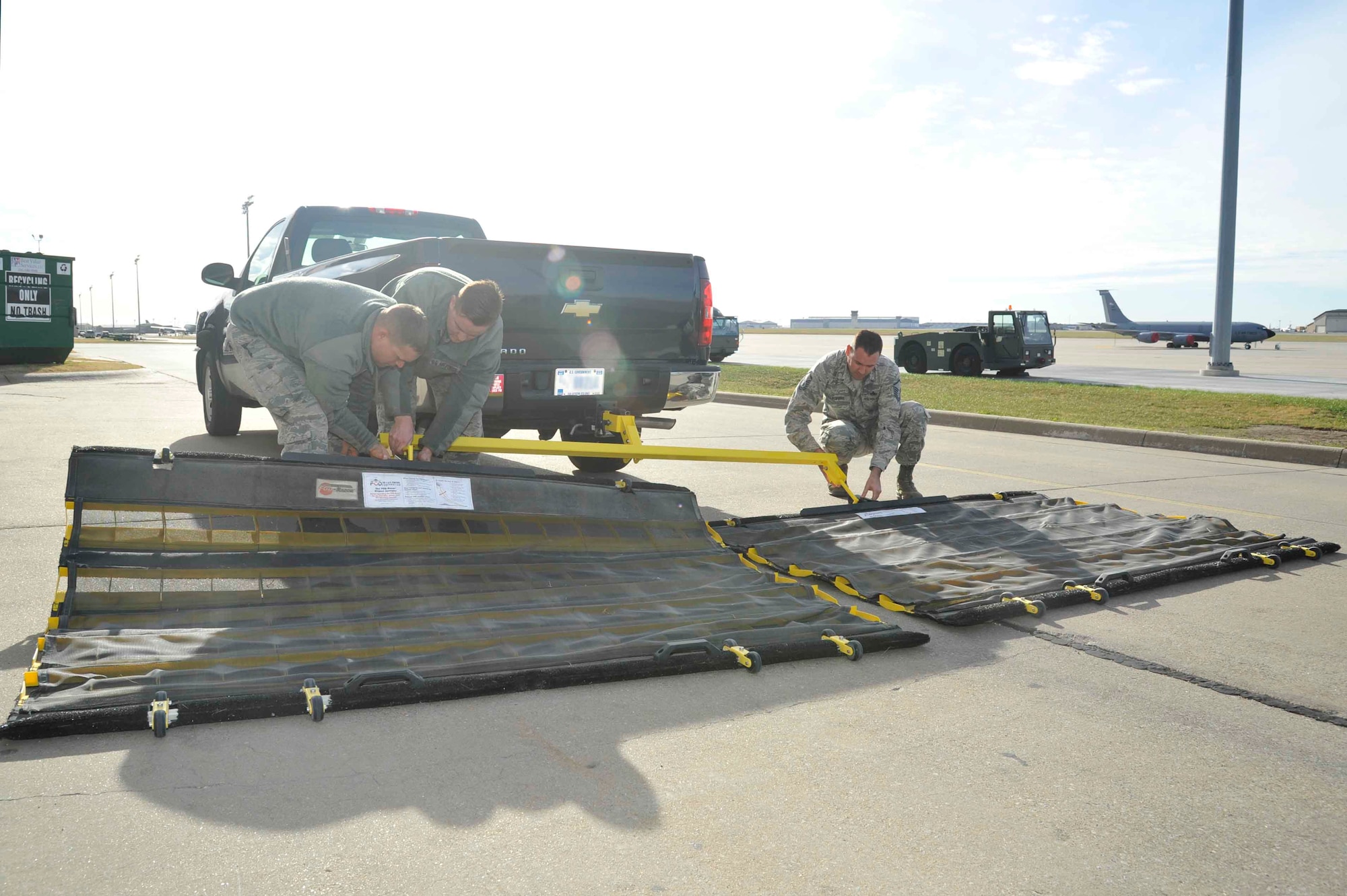 Senior Airman Patrick Bartosavage, 931st Aircraft Maintenance Squadron KC-46 equipment crew chief, Senior Airman Andrew Kruckman, 22nd AMXS assistant vehicle control officer, and Master Sgt. Erik Louviere, 22nd Maintenance Group FOD monitor, attach the base’s new dual FOD system to a truck Dec. 2, 2016, at McConnell Air Force Base, Kan. The equipment, which is valued at approximately $11,000, was recently purchased to support the base’s FOD prevention program and is used weekly to clear debris from the flightline. (U.S. Air Force photo/Airman 1st Class Erin McClellan)
