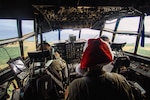 Crewmembers of a C-130 Hercules assigned to the 36th Airlift Squadron fly over remote a Micronesian island during Operation Christmas Drop 2016, Dec. 5, 2016. This year marks the 65th year of Operation Christmas Drop, which began in 1952, making it the world's longest-running airdrop mission.