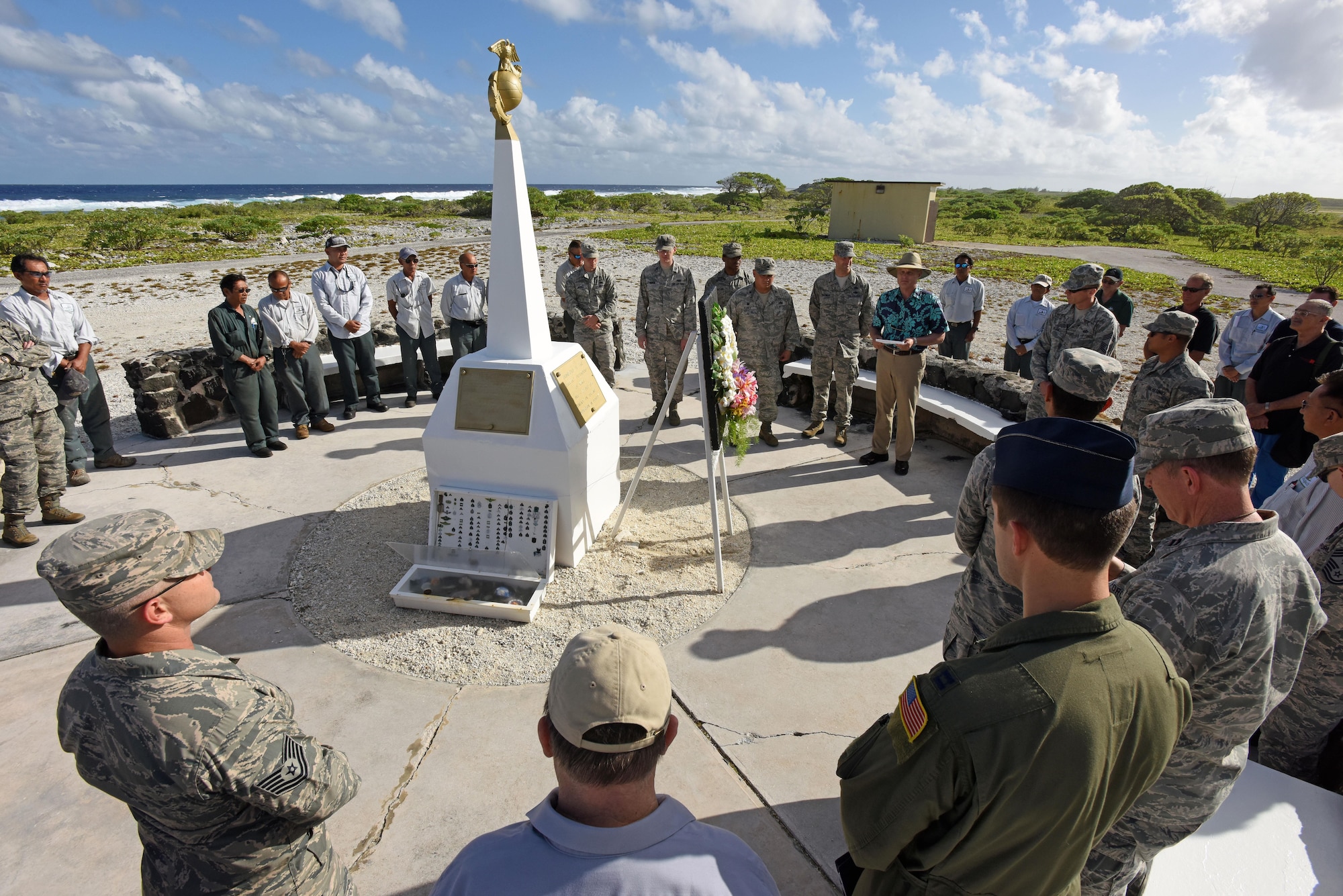 WAKE ISLAND ATOLL-- Battle of Wake Island 75th anniversary ceremony attendees, including leadership from Pacific Air Forces Regional Support Center and 11th Air Force, pay thier respects with a wreath laying and moment of silence at the Marines memorial. The Battle of Wake Island occured just a few hours after the attack on Pearl Harbor, Hawaii, on Dec. 7, 1941. (U.S. Air Force photo/Tech. Sgt. John Gordinier)