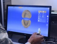Staff Sgt. Khodie Morgan, 341st Medical Operations Squadron dental laboratory technician, creates a digital case file of a crown pattern using a computer-aided design and manufacturing machine in the dental laboratory Dec. 5, 2016, at Malmstrom Air Force Base, Mont. Creating a case file is the beginning process to create a crown. (U.S. Air Force photo/Senior Airman Jaeda Tookes)