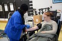 Tammie Berry, Mississippi Blood Services, prepares to draw a donation from Staff Sgt. Viviana Chalfonte, 14th Medical Operations Squadron Force Health Management noncommissioned officer in-charge, Dec. 9, 2016, at a blood drive on Columbus Air Force Base, Mississippi. MBS is a non-profit blood service, whose mission is to provide a safe and adequate supply of voluntarily donated blood and blood components for patients in hospitals and to offer related services to hospitals and other medical facilities. (U.S. Air Force photo by Senior Airman John Day)