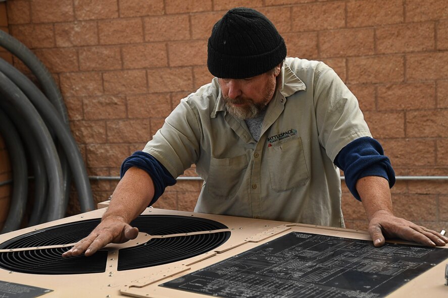 Michael, an aerospace ground equipment mechanic with the 432nd Wing/432nd Air Expeditionary Wing, inspects an air conditioning unit Dec. 5, 2016, at Creech Air Force Base, Nev. The unit is attached to a ground control station to maintain an optimal temperature and ensure its functionality. (U.S. Air Force photo by Airman 1st Class James Thompson) 