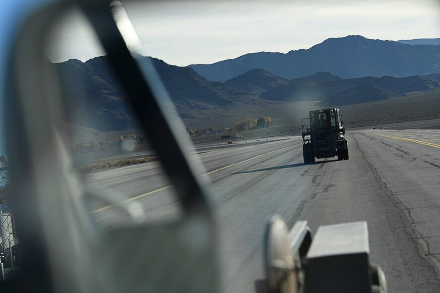 Robert, an aerospace ground equipment mechanic with the 432nd Wing/432nd Air Expeditionary Wing, drives a forklift across the runway Dec. 6, 2016, at Creech Air Force Base, Nev. The forklift is normally used to move and manipulate equipment during their semi-annual equipment inspections. (U.S. Air Force photo by Airman 1st Class James Thompson) 