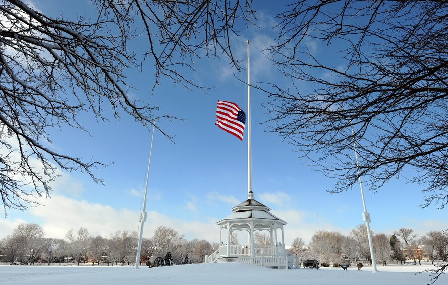 The flag was at half-staff on the Offutt AFB parade ground as the snow began to fall in December 2012. Don't get caught unprepared for the frigid weather this winter, take precautions to ensure success if you ever get caught out in the cold. (U.S. Air Force photo by Josh Plueger)