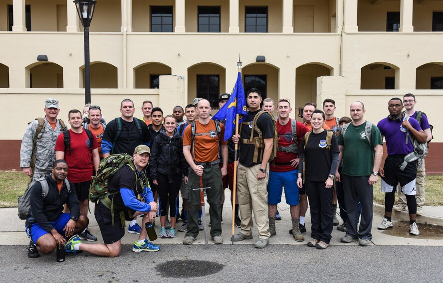 Airmen assigned to the 608th Air Operations Center participate in a ruck march as part of a fitness program capstone event at Barksdale Air Force Base, La., Dec. 12, 2016. The 608th AOC Commander’s Advanced PT Program requires participants to complete 3,000 push-ups, 3,000 sit-ups, run/walk 120 miles and complete a 6.08-mile ruck march within a 90-day period to earn their name on an ingot attached to the unit’s fitness plaque. (U.S. Air Force photo by Senior Airman Luke Hill)